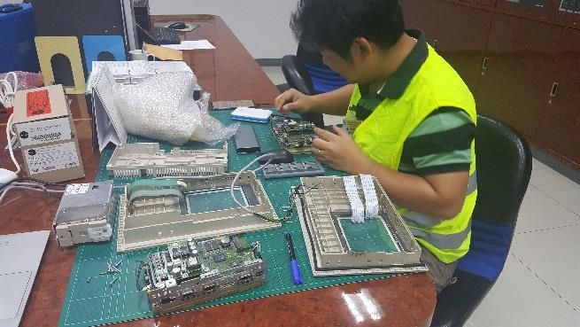 JPK engineer repairing an HMI board in the workshop